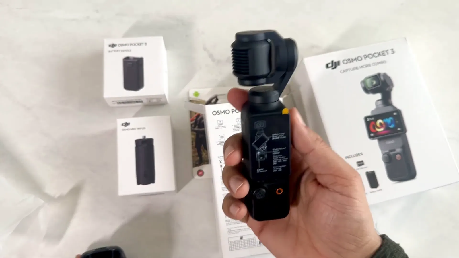 DJI Osmo Pocket 3 in hand after removing protective case