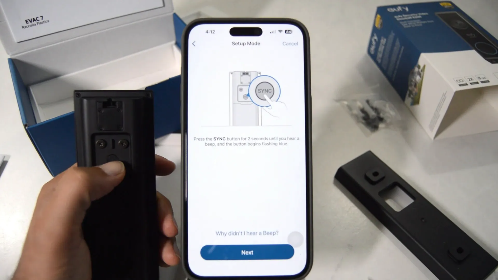 Pressing the sync button on the Eufy e340 doorbell