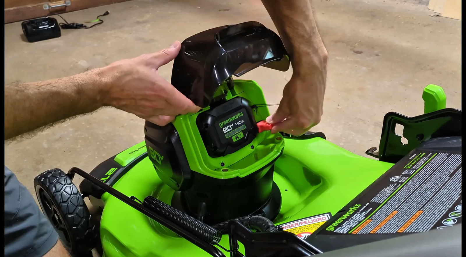 Inserting battery into lawnmower with safety key