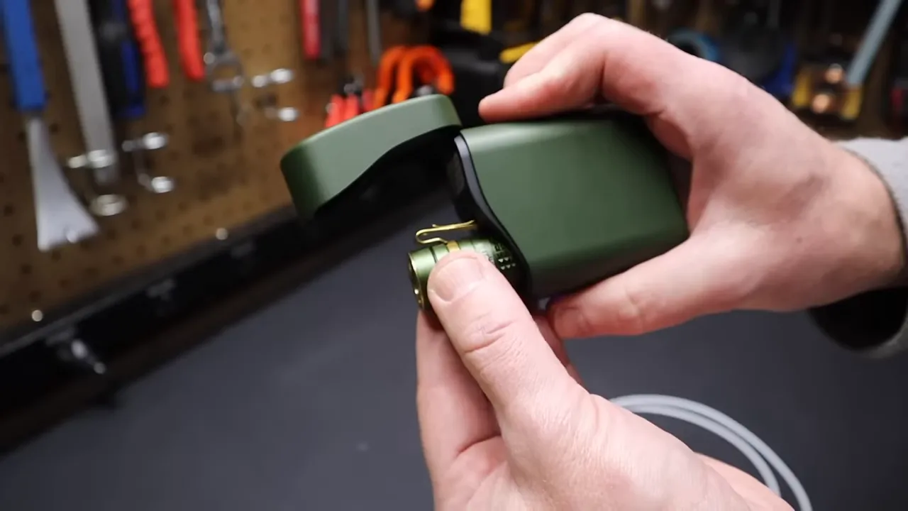 Olight Baton 4 flashlight with charging case, light pulled out
