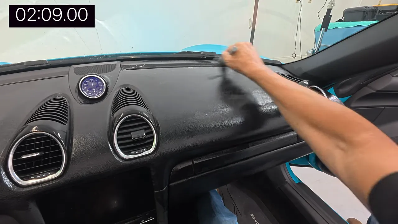 Brushing dashboard texture with circular motions, focusing on ridges and vents