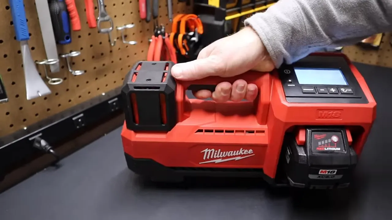 Milwaukee inflator and Olight Baton 4 set beside a tool bag