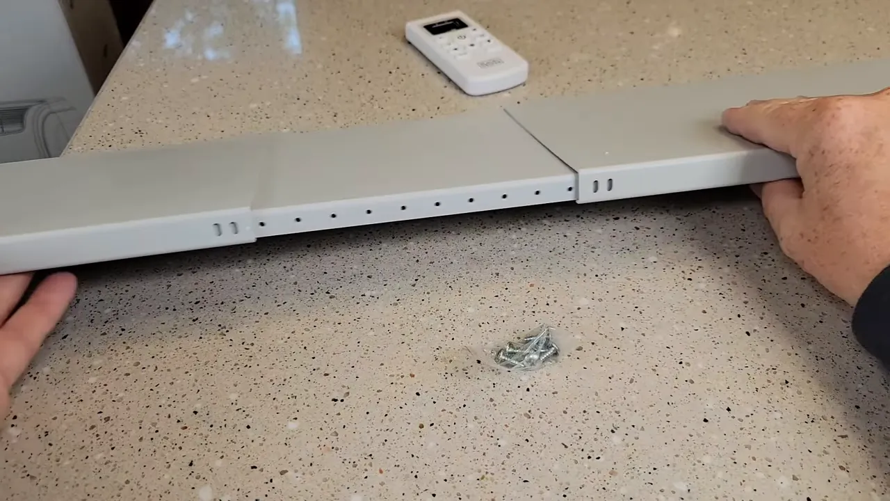 Sliding the window panel to desired width and using metal screws