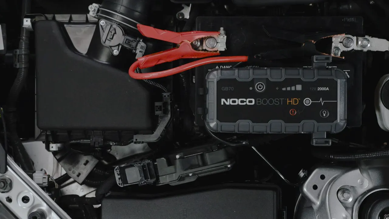 NOCO Boost GB70 powerful jump starter next to a full-size truck