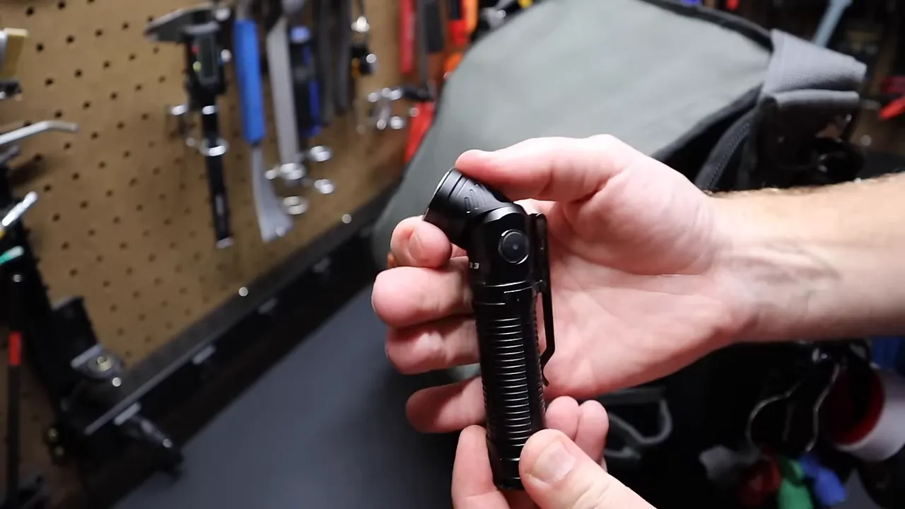 Rofis R3 angle-head flashlight clipped to bag
