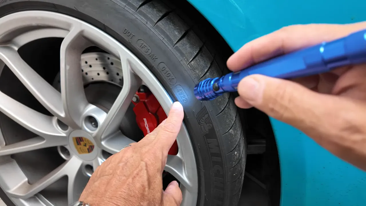 Close-up of tire DOT code on sidewall