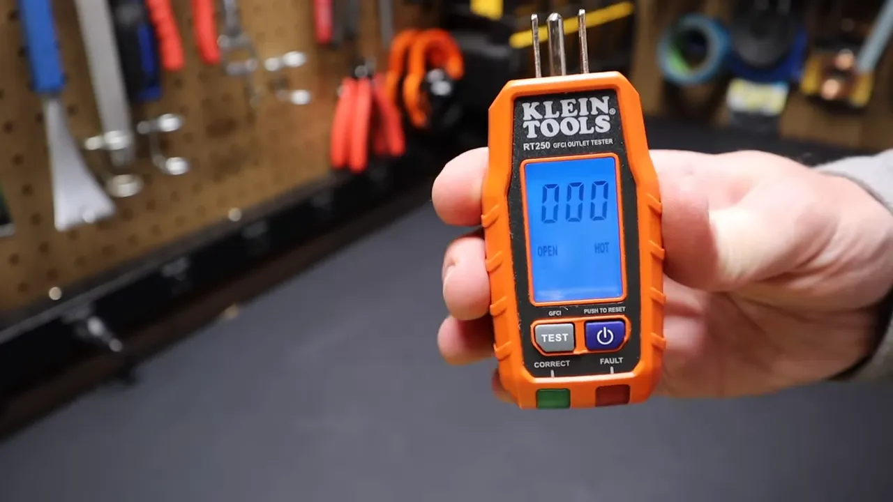 Klein Tools GFCI outlet tester plugged in with display lit