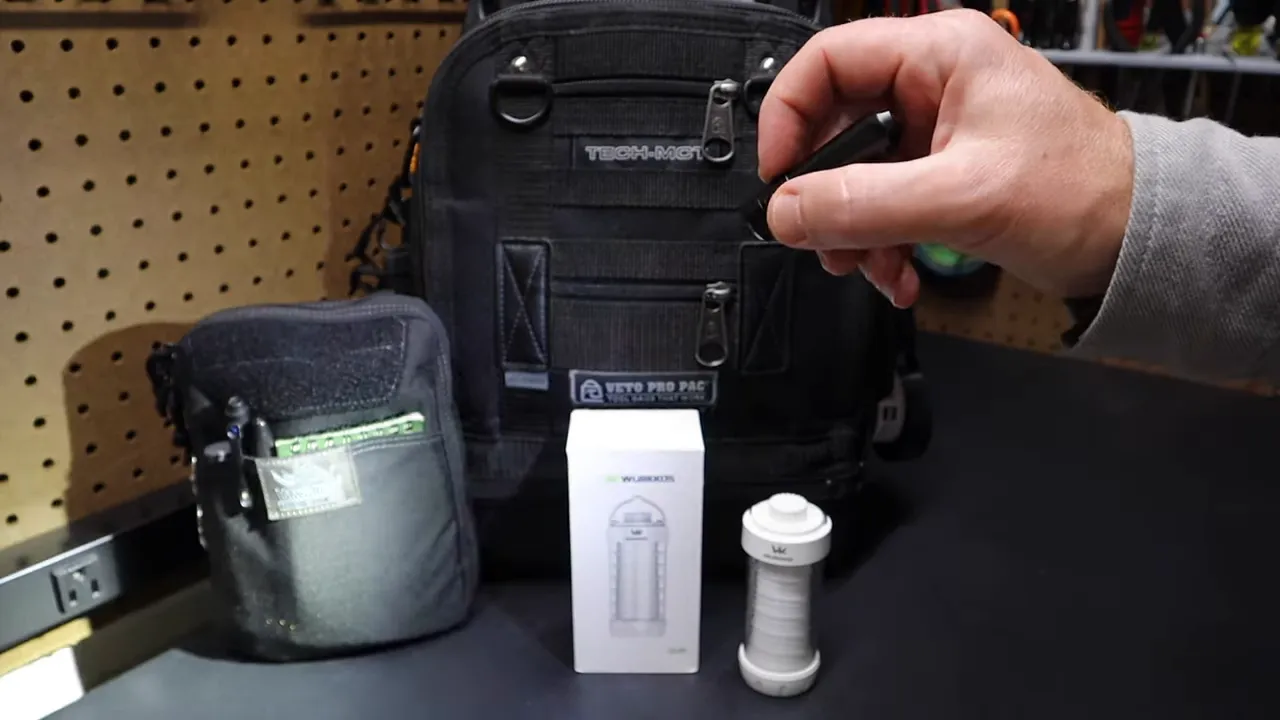 ThruNite Ti showing the metal switch and a yellow charging indicator LED