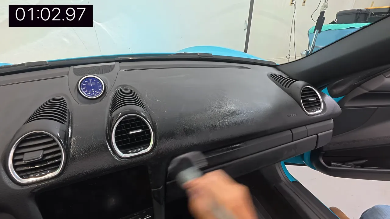 Spraying Chemical Guys into detailing brush, not onto dashboard