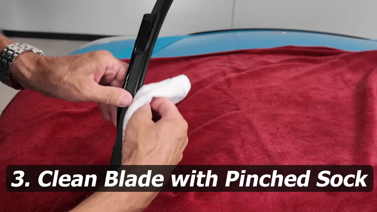 Pinching a WD-40 soaked sock around the wiper blade