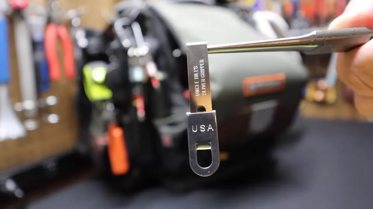 Uncle Bill's micro tweezers in holder clipped to a tool bag
