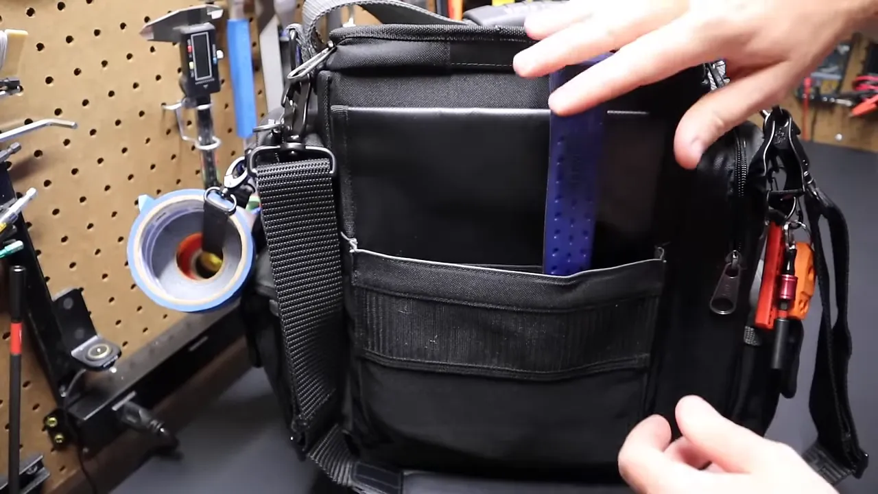 Estwing 16oz hammer stored in back pocket next to Husky parts bin