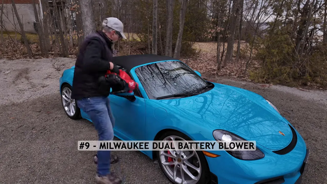 Milwaukee dual-battery blower blowing water off a hood
