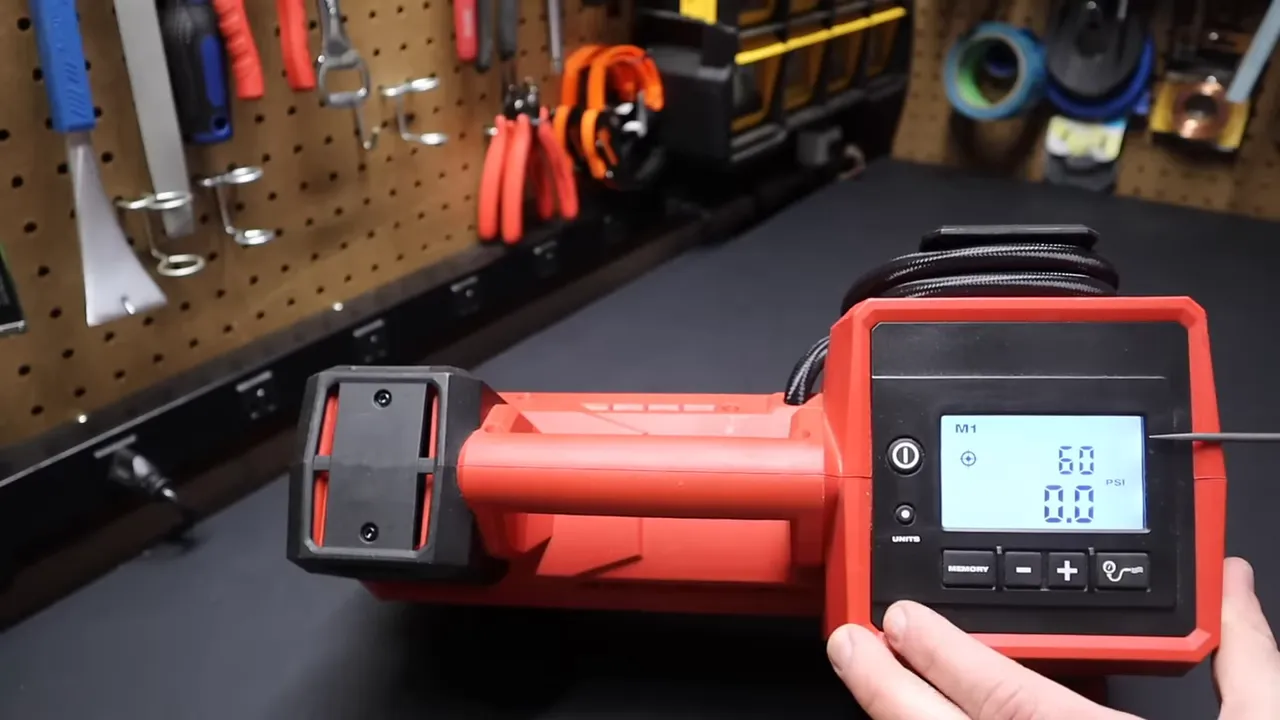 Milwaukee M18 inflator with hose attached inflating a car tire