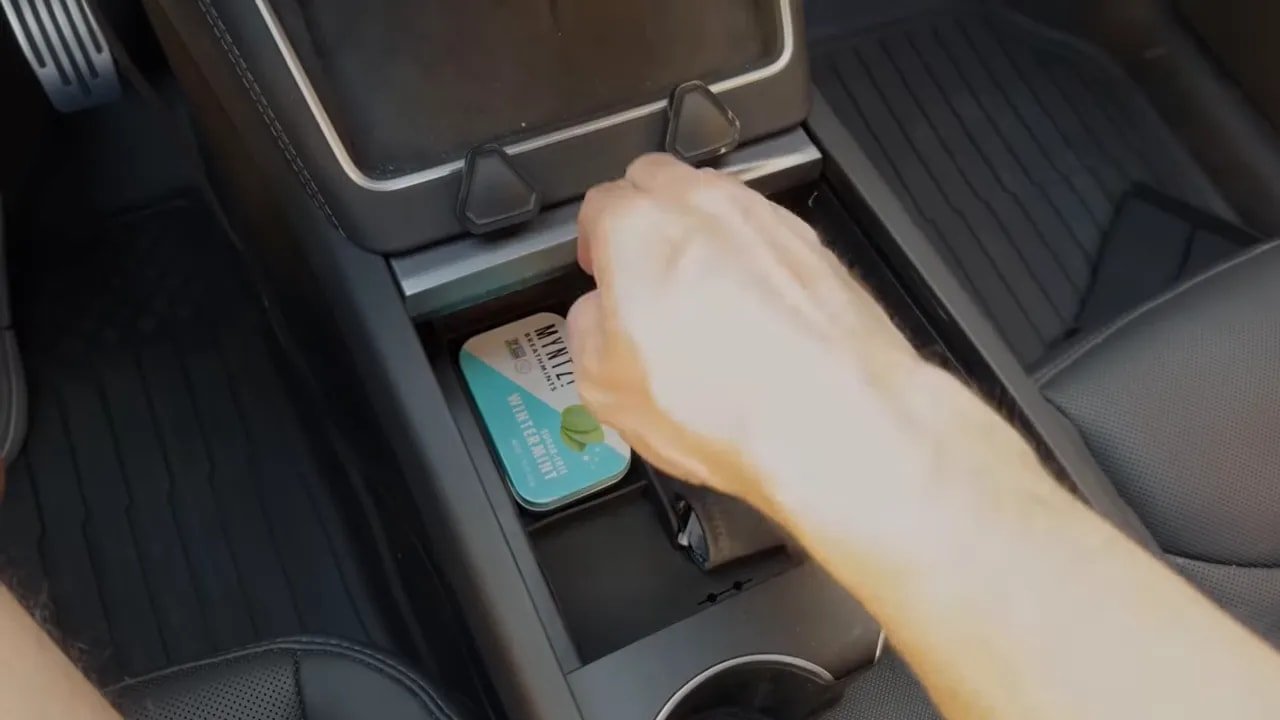 Tesla center console organizer with divided compartments holding cards and small accessories